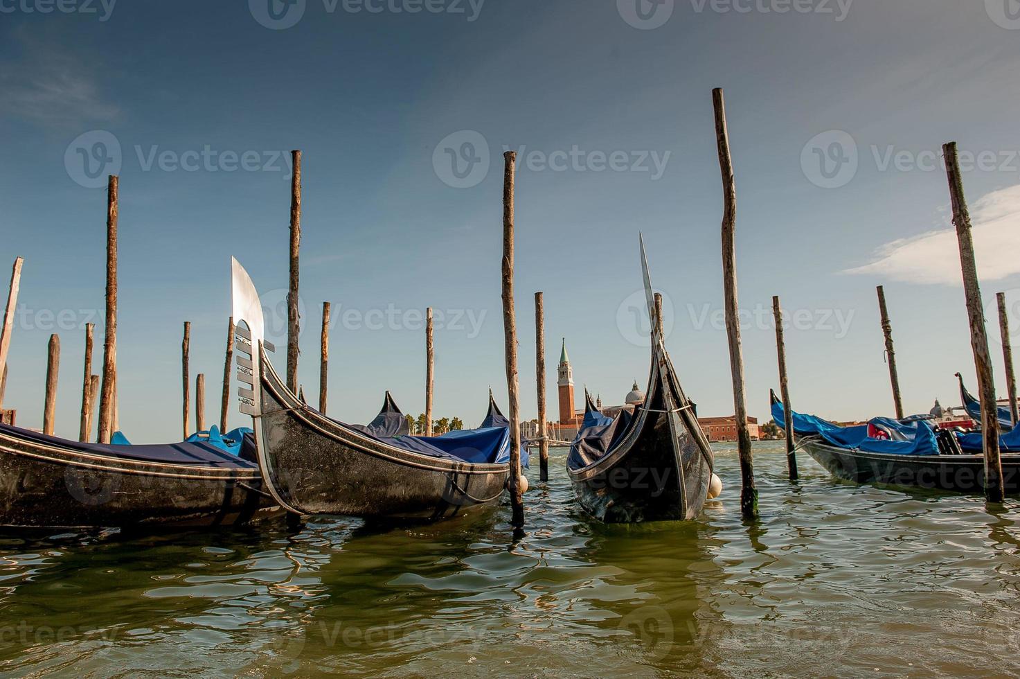 Gondola at jetty with background giudecca in venice photo
