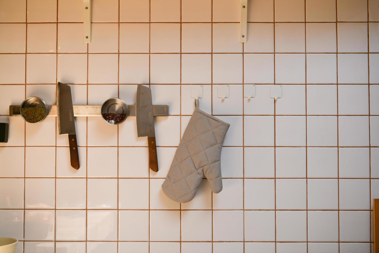 Cooking pan hanging on the kitchen wall after cleaning is complete. photo