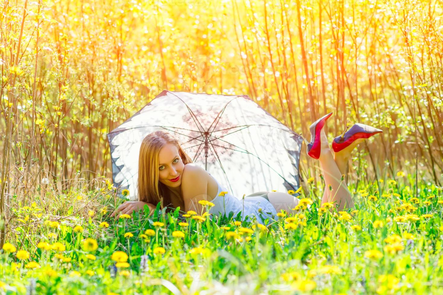 Sensual woman in a flowery meadow photo