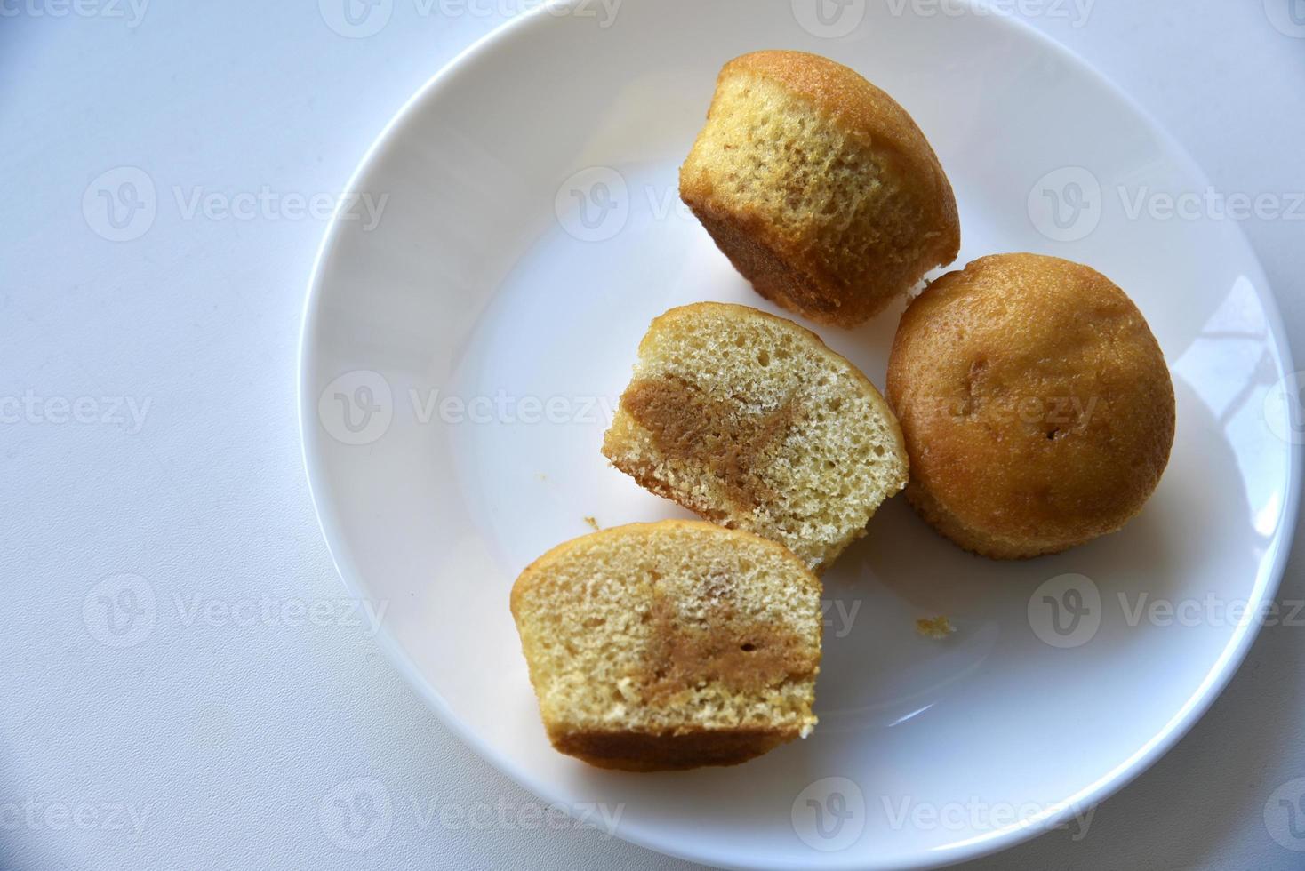 Sweet fluffy muffin buns on a white plate photo