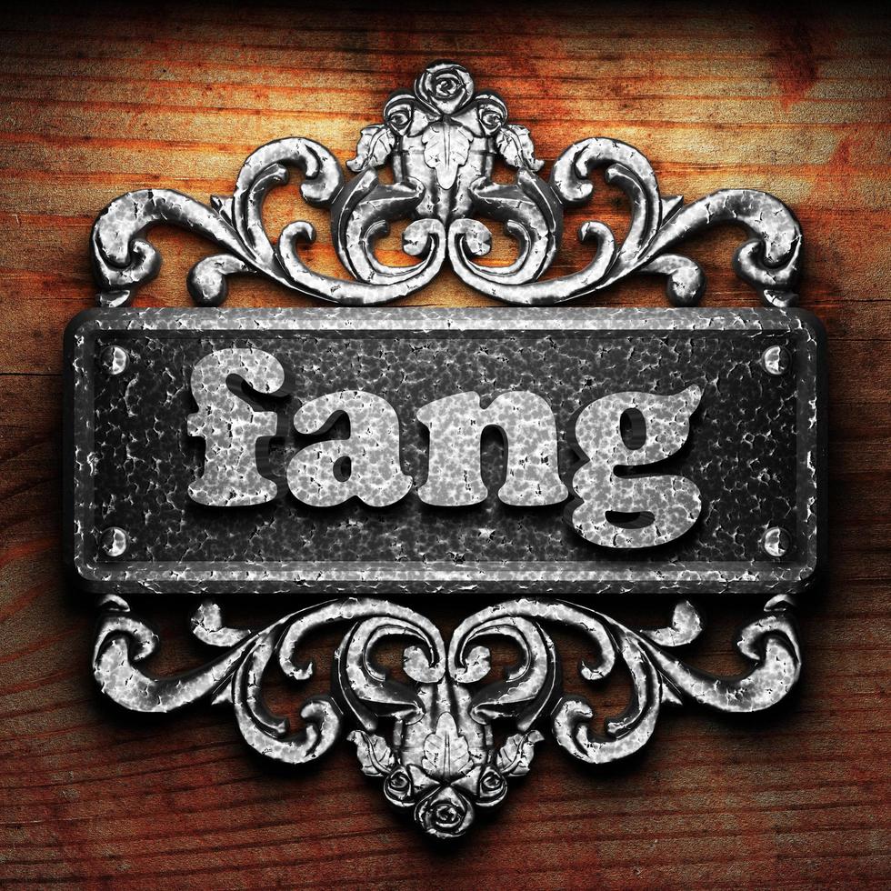 fang word of iron on wooden background photo