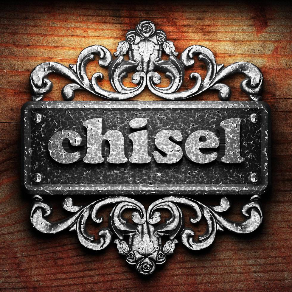 chisel word of iron on wooden background photo