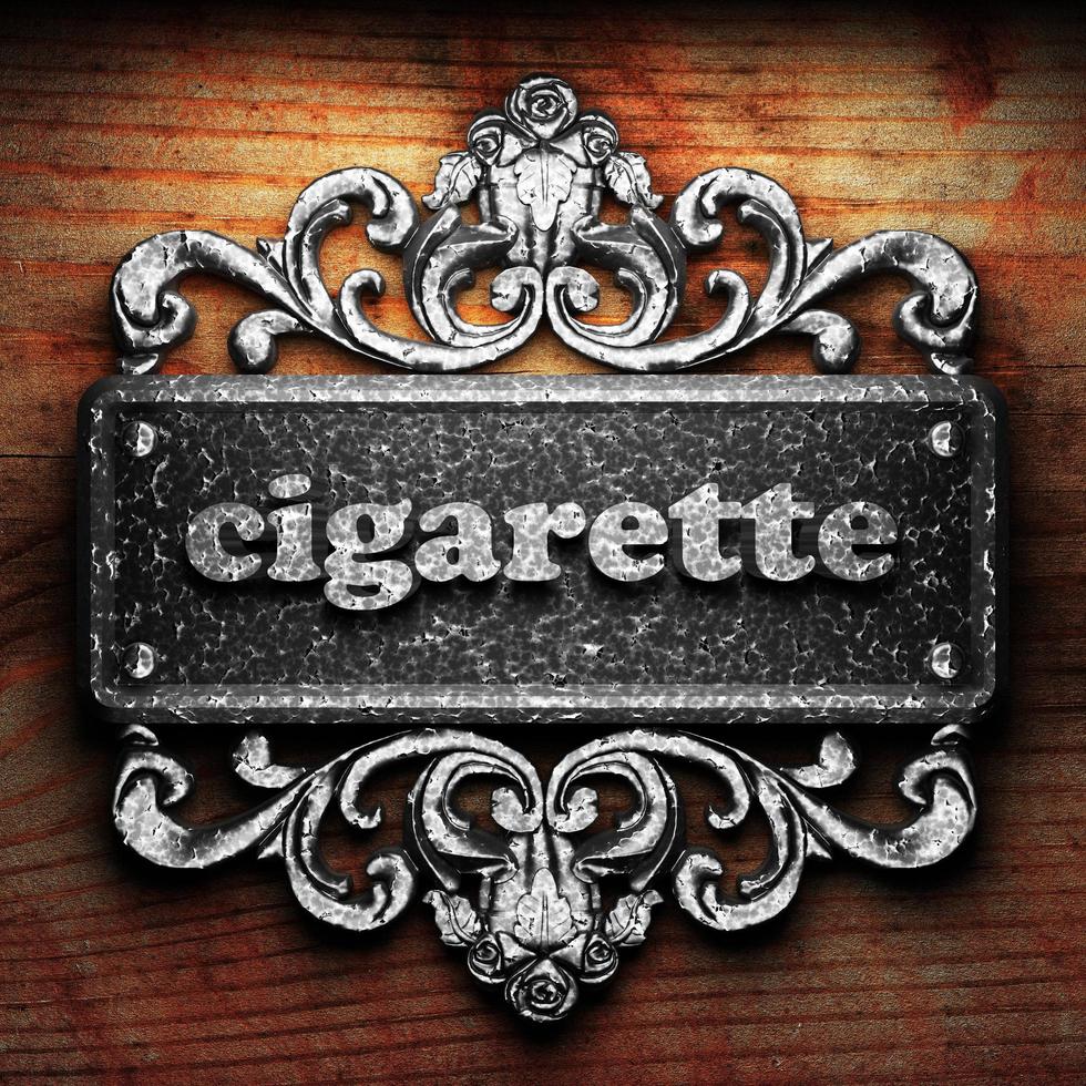 cigarette word of iron on wooden background photo