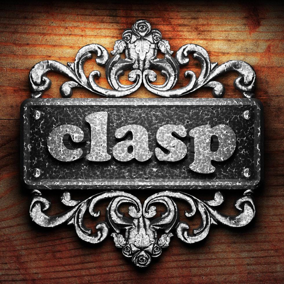 clasp word of iron on wooden background photo