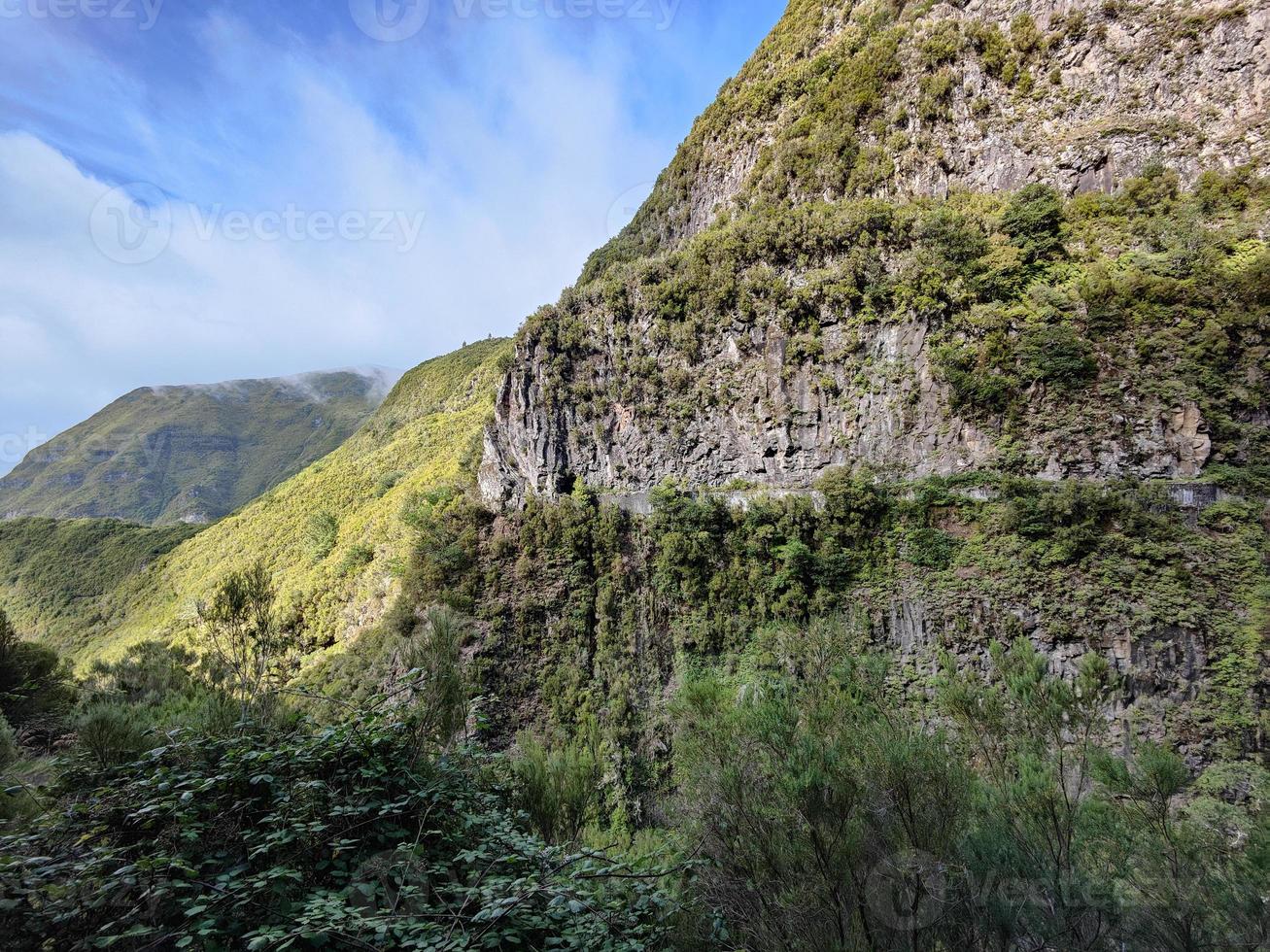 Amazing natural and tropical holidays destinations to enjoy nature. Views of the mountains with vibrant green colors. Madeira island,m Portugal. Hiking and adventurous life. Sun with clouds. Colors. photo