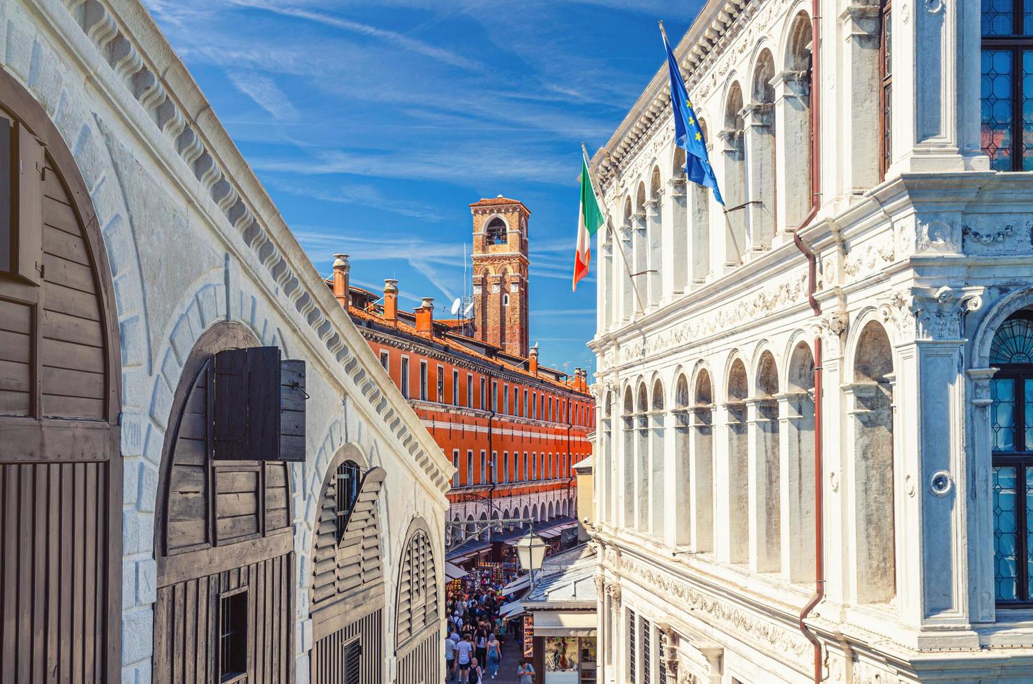 Venice, Italy, September 13, 2019 Palazzo dei Camerlenghi palace building and bell tower campanile in Venice photo