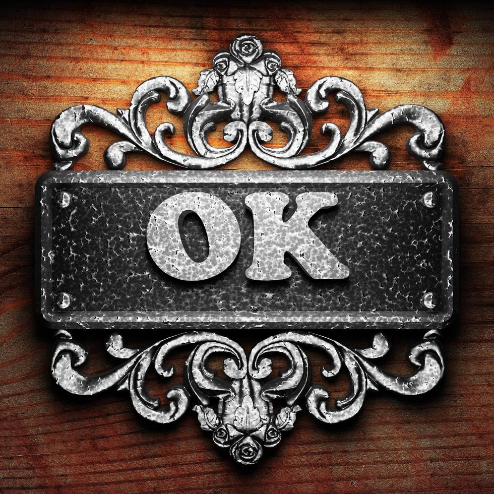 OK word of iron on wooden background photo