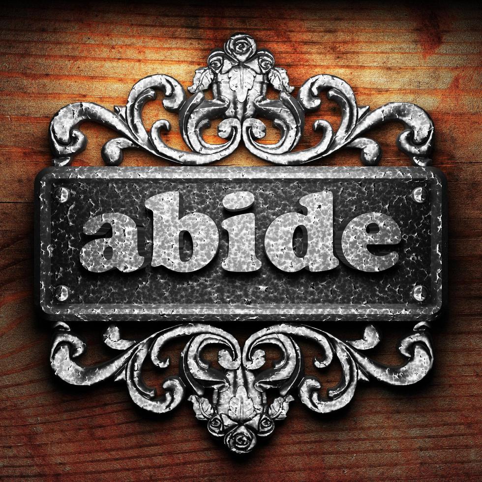 abide word of iron on wooden background photo