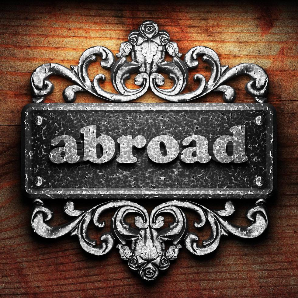 abroad word of iron on wooden background photo