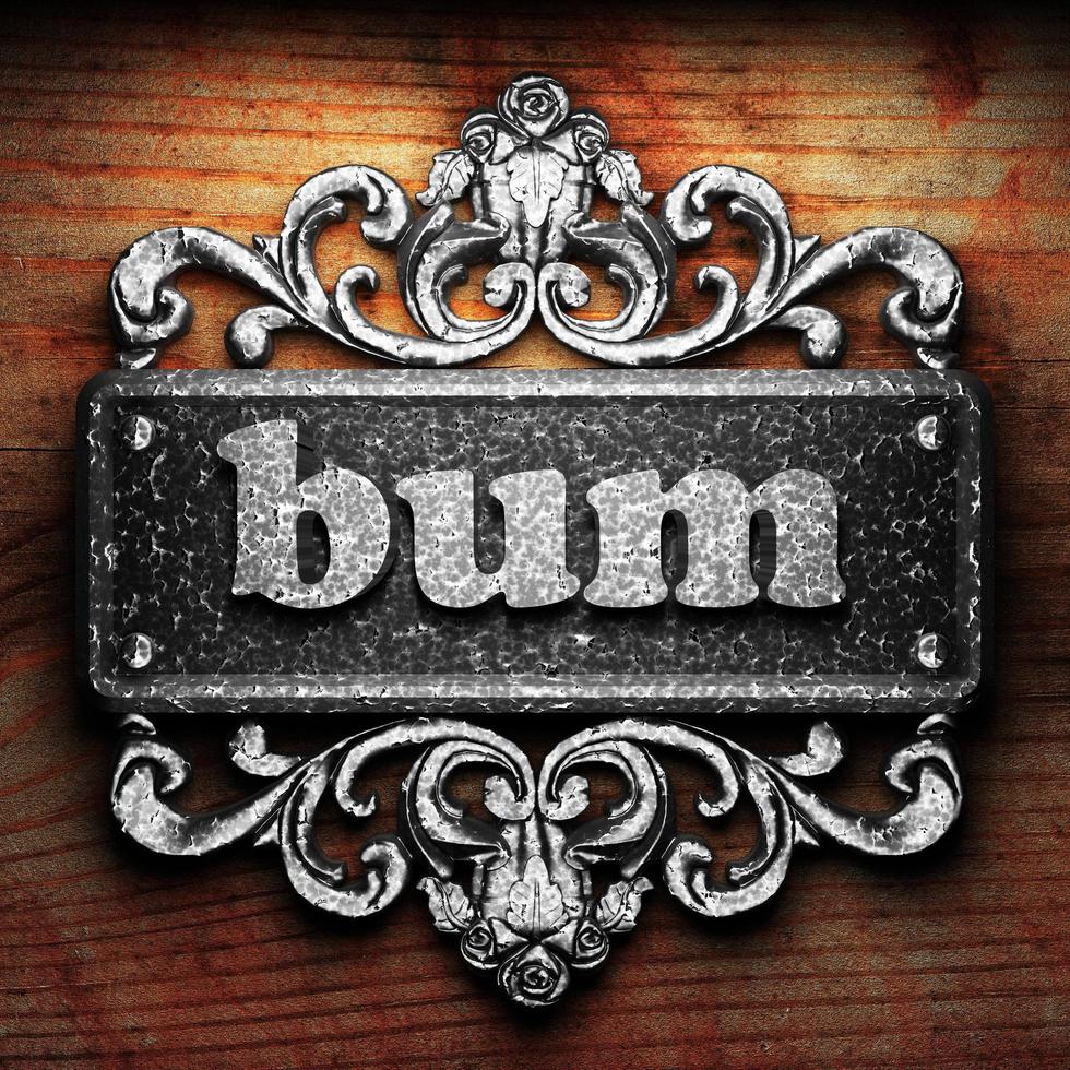 bum word of iron on wooden background photo