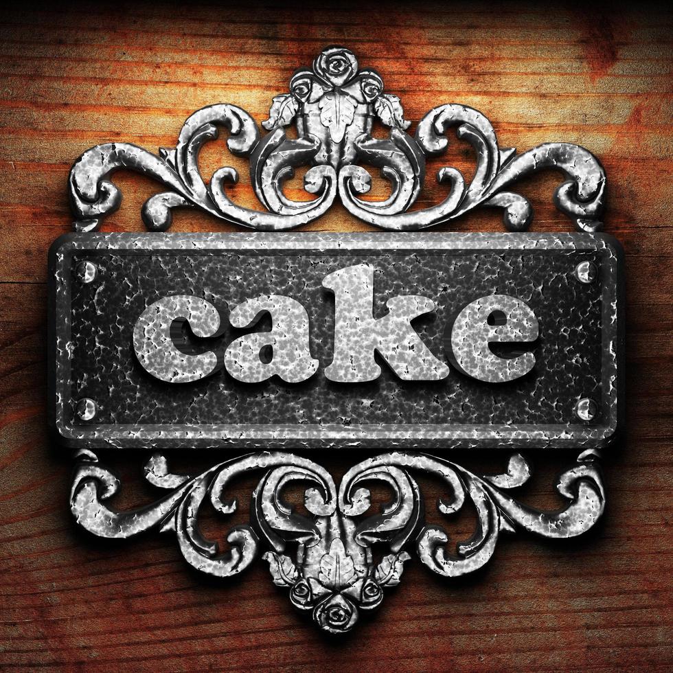 cake word of iron on wooden background photo