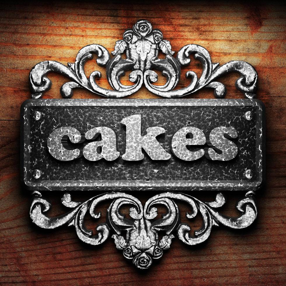 cakes word of iron on wooden background photo