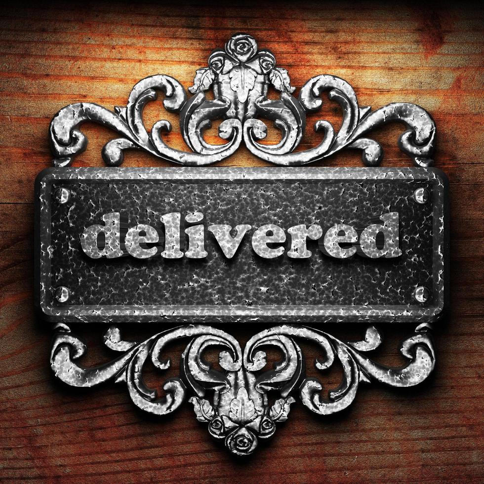 delivered word of iron on wooden background photo