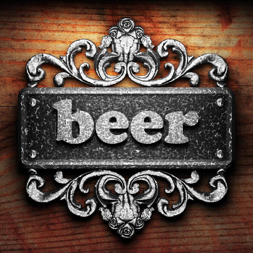 beer word of iron on wooden background photo