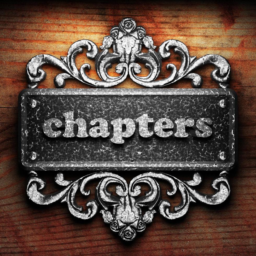 chapters word of iron on wooden background photo