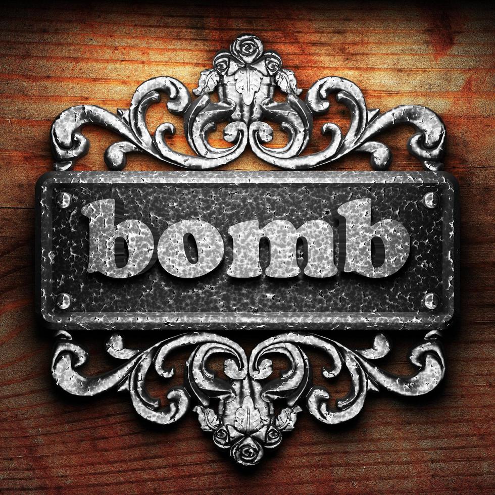 bomb word of iron on wooden background photo