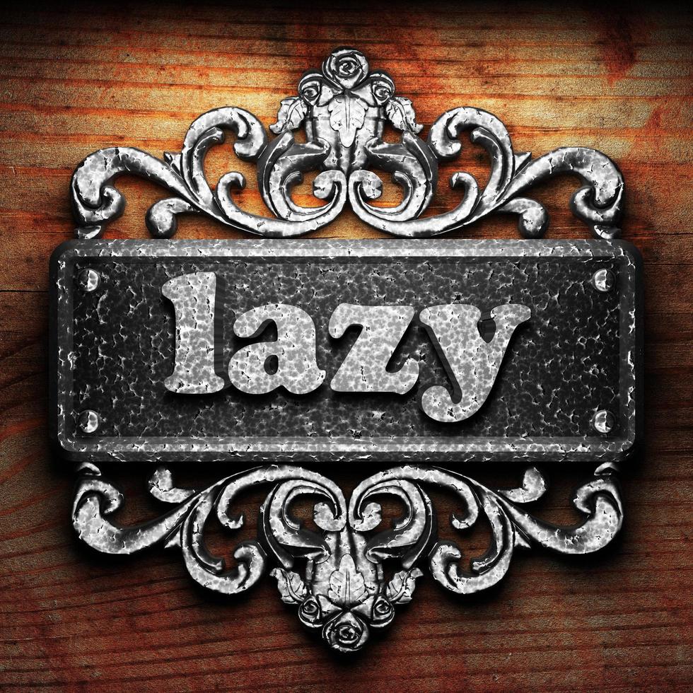 lazy word of iron on wooden background photo