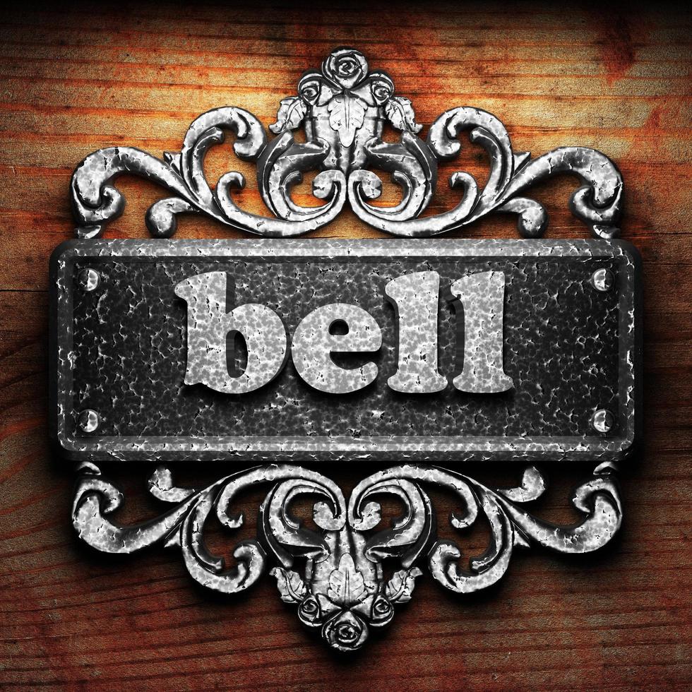 bell word of iron on wooden background photo
