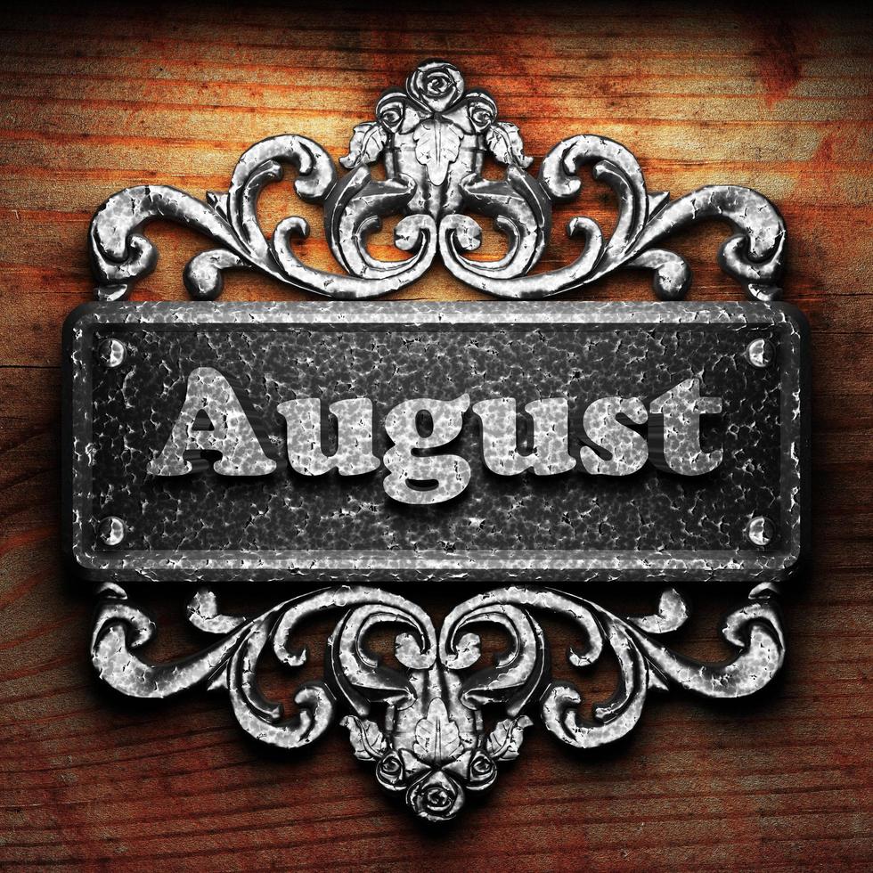 August word of iron on wooden background photo