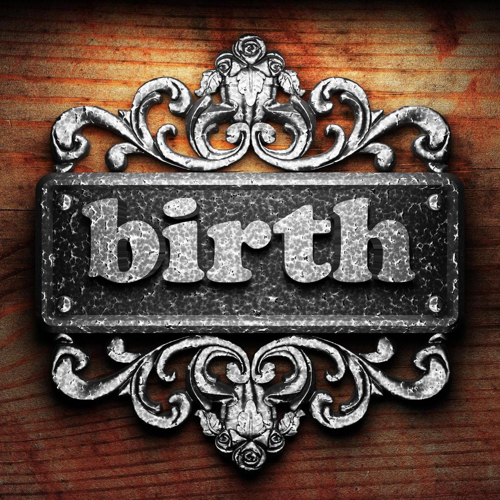 birth word of iron on wooden background photo