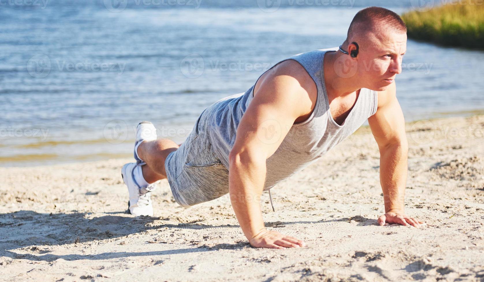 Fitness man training push up photo