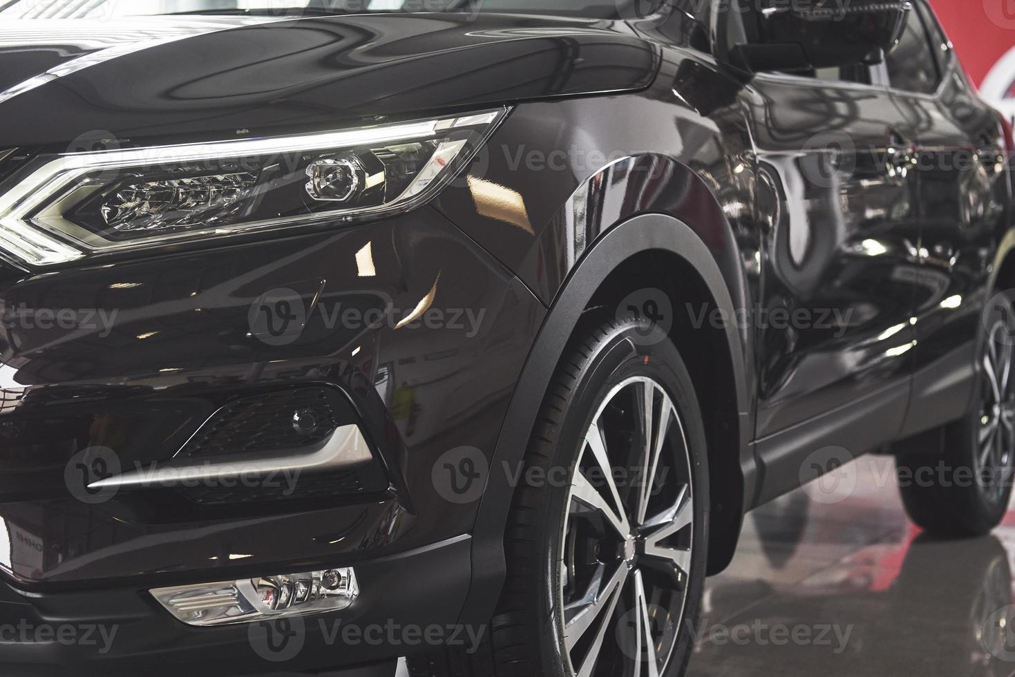 The headlights and the hood of a black luxury car photo