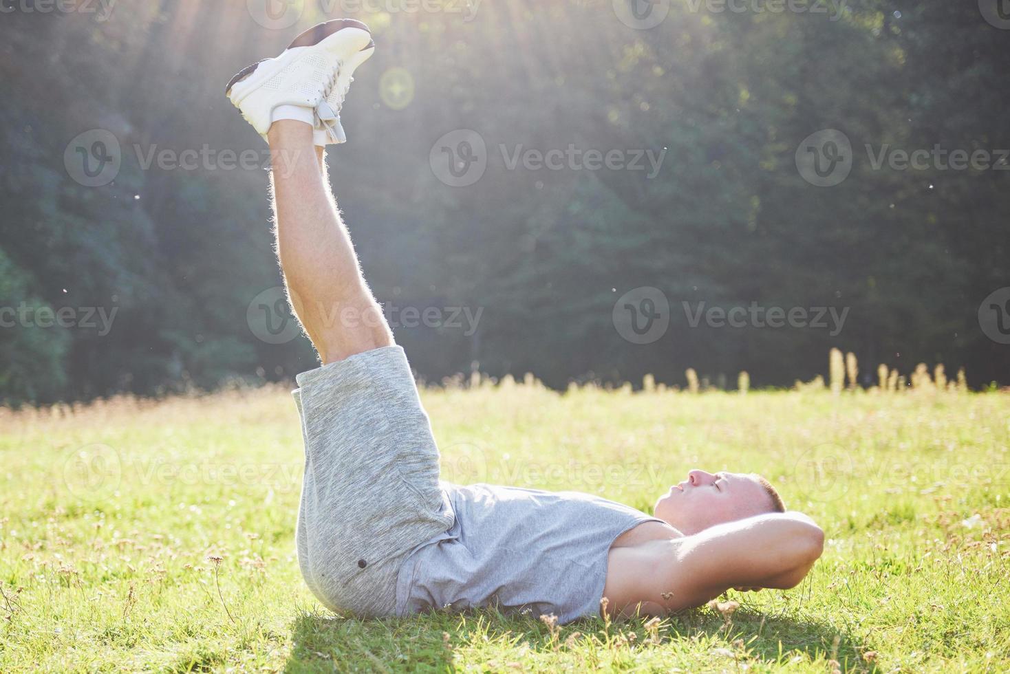 A young sportsman getting ready for athletic and fitness training outdoors. Sport, exercise, fitness, workout. Healthy lifestyle photo