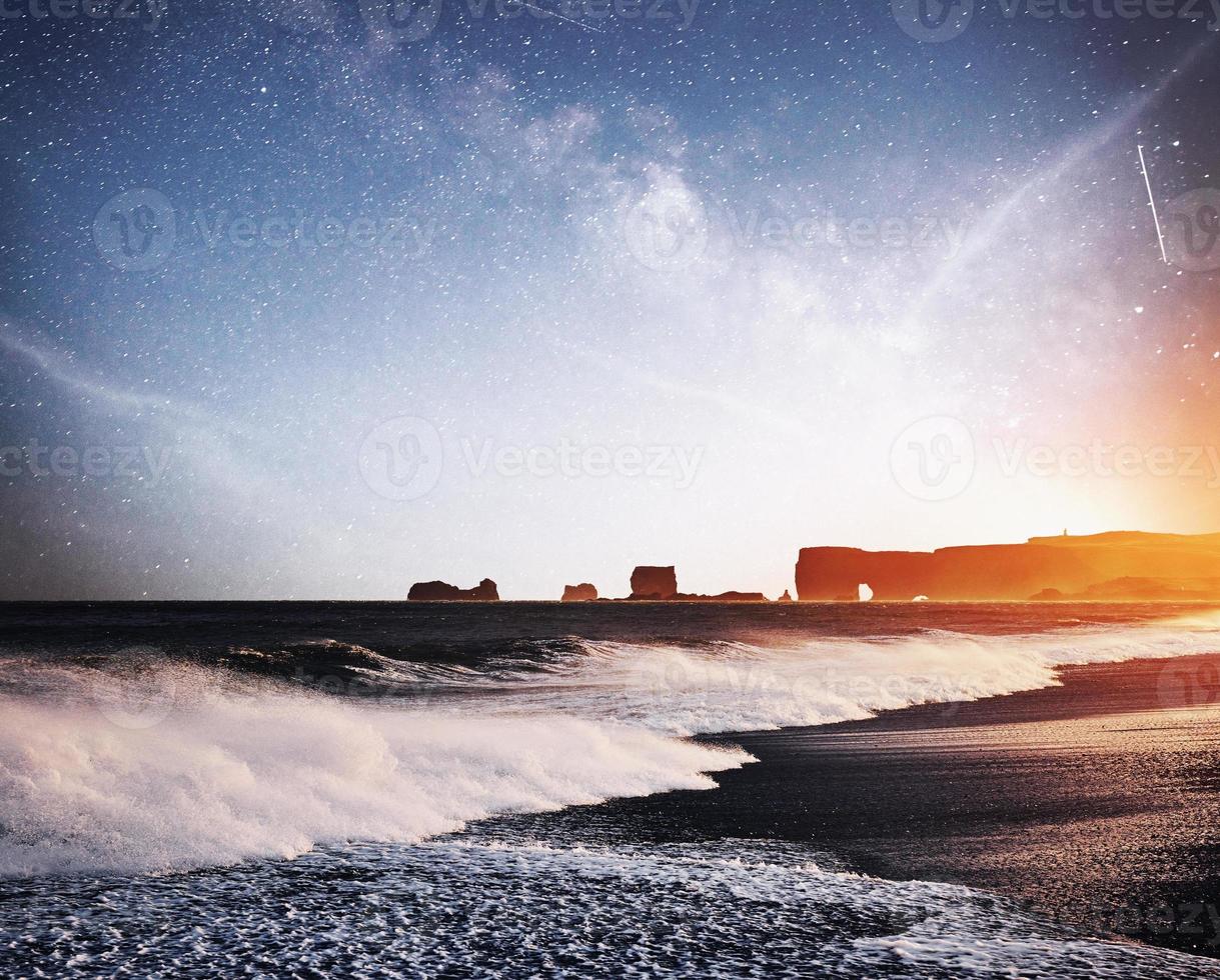 The Rock Troll Toes. Reynisdrangar cliffs. Black sand beach. Iceland. Fantastic starry sky and the milky way photo