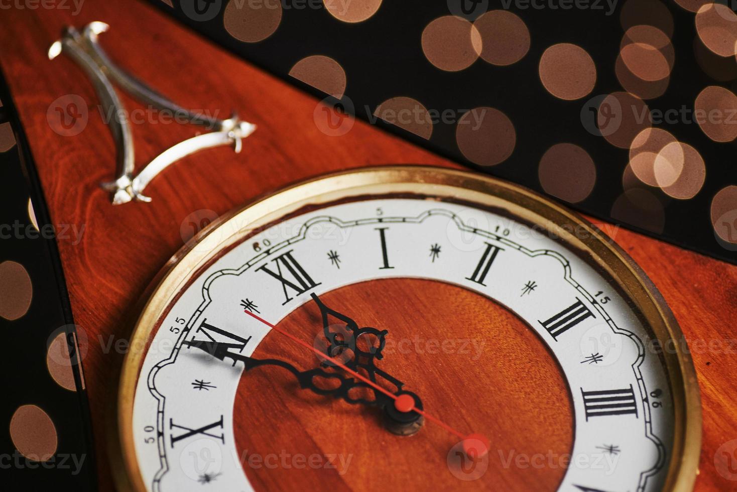 Happy New Year at midnight 2018, Old wooden clock with holiday lights photo