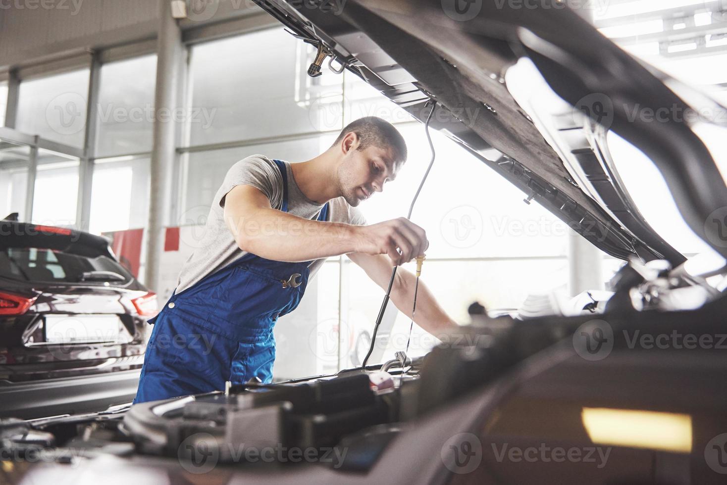 Auto mechanic working in garage. Repair service photo