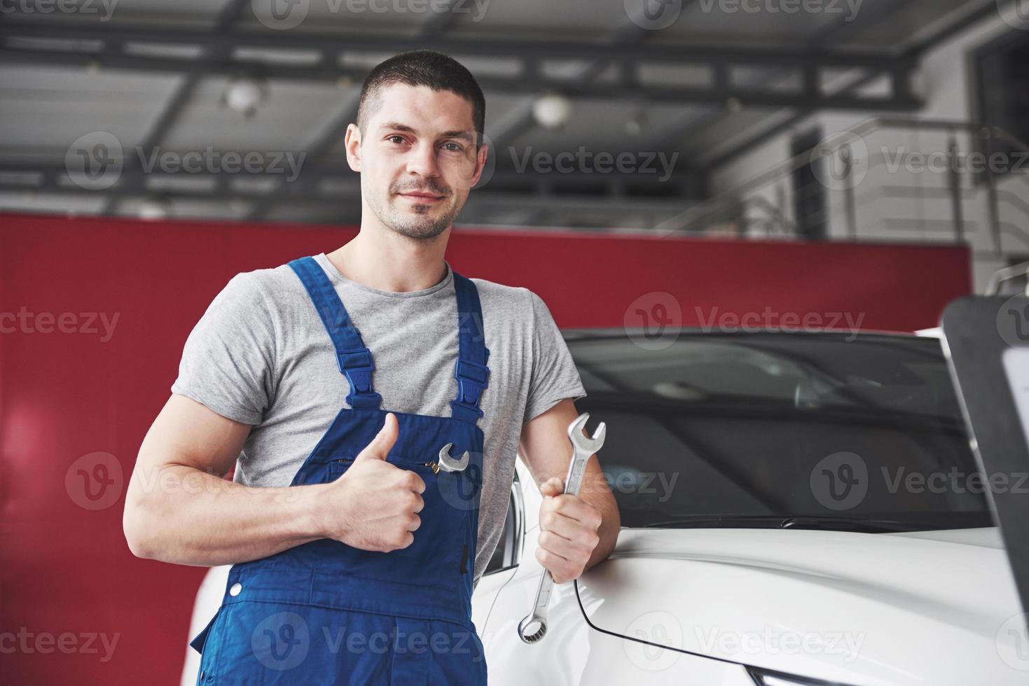 Hand of car mechanic with wrench. Auto repair garage photo