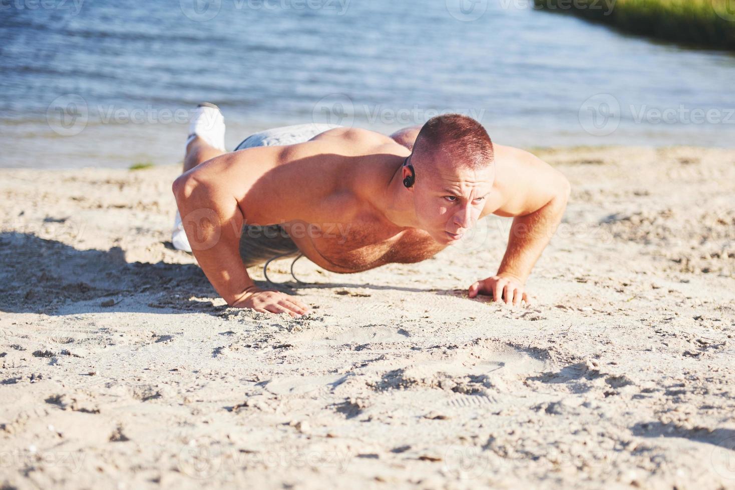 Fitness man training push up photo