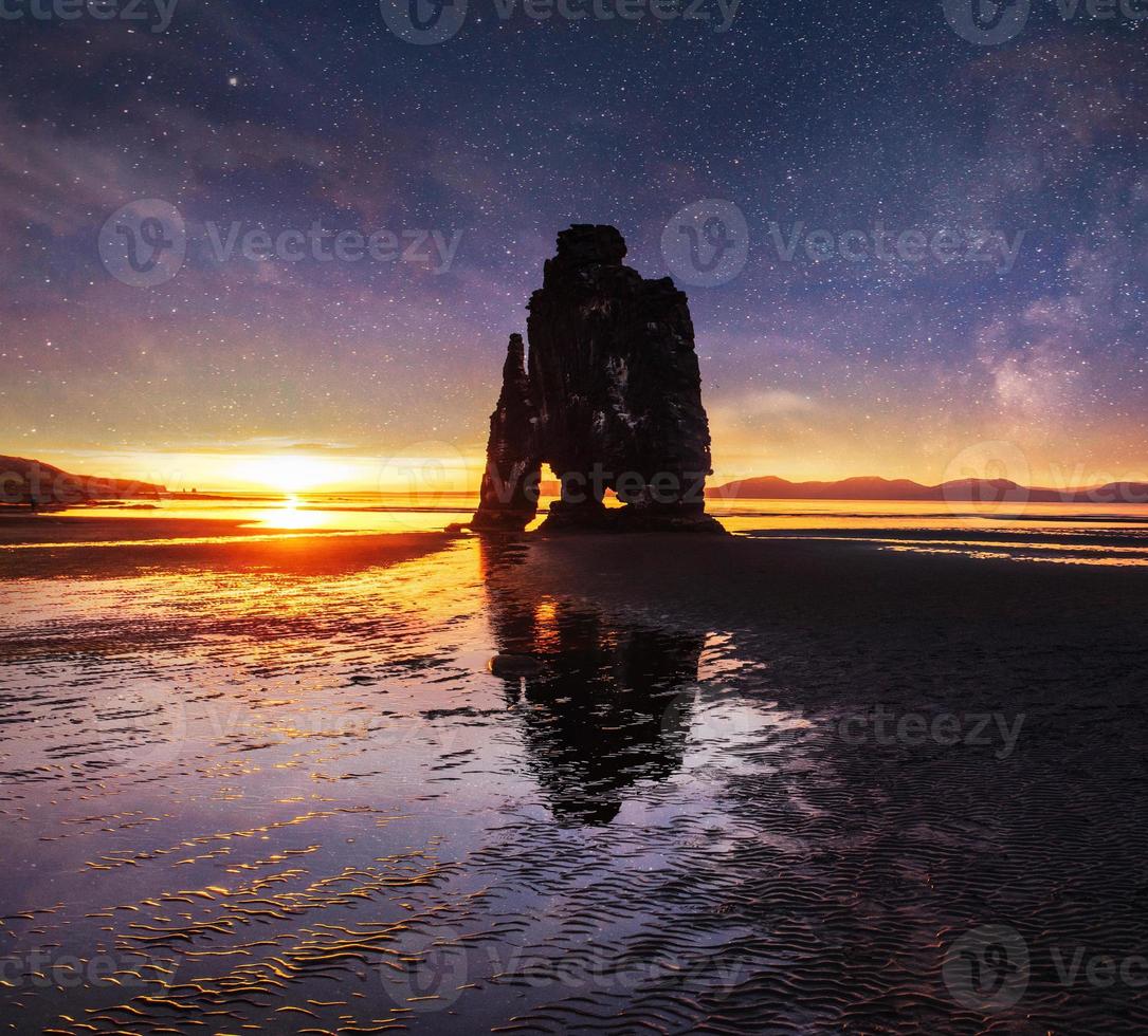 starry sky in a spectacular rock in the sea on the Northern coast of Iceland. Legends say it is a petrified troll photo