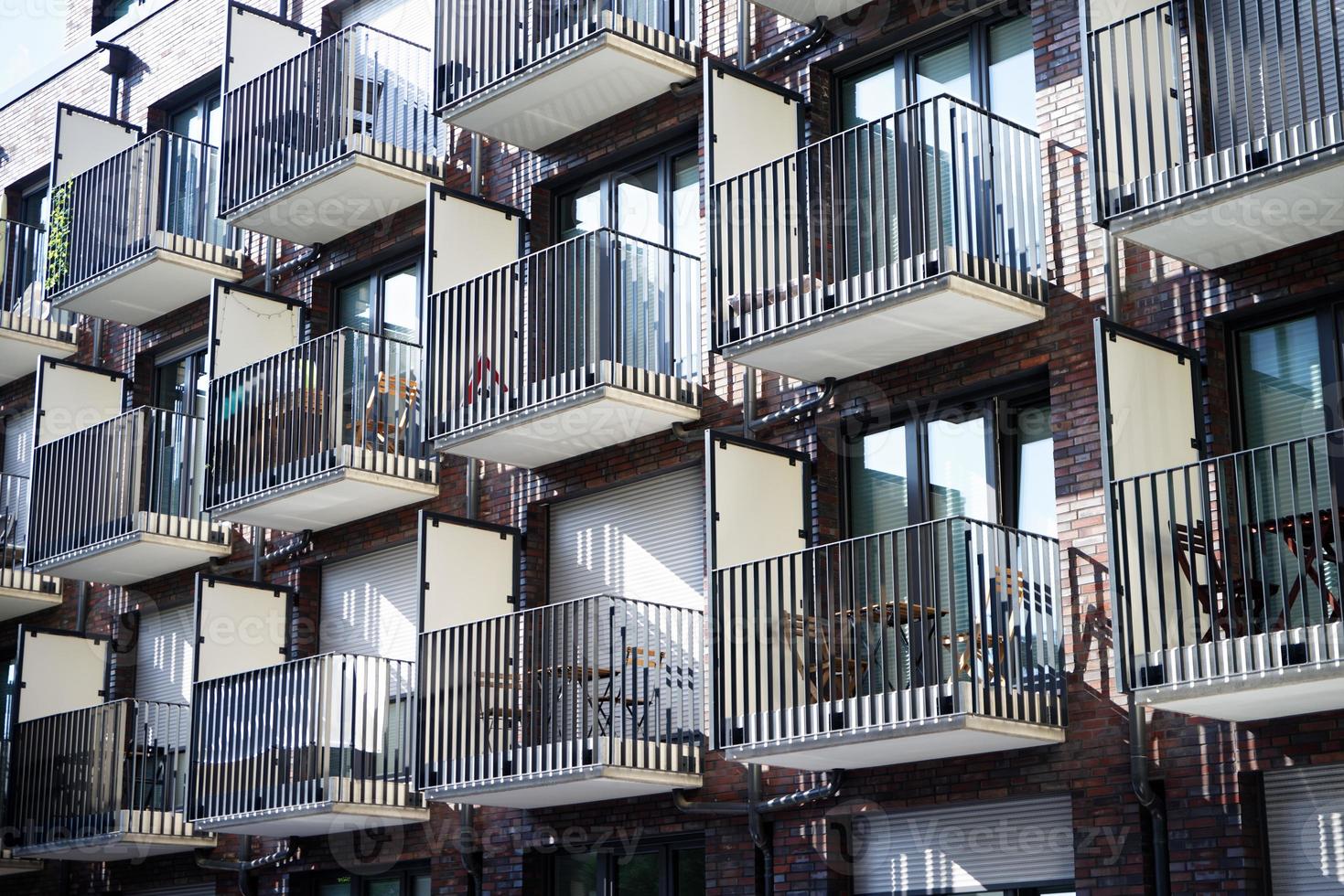 many small balconies with tables and chairs at a student residence in cologne photo