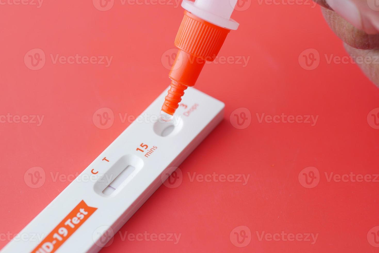 Negative Covid-19 test kit on red background photo