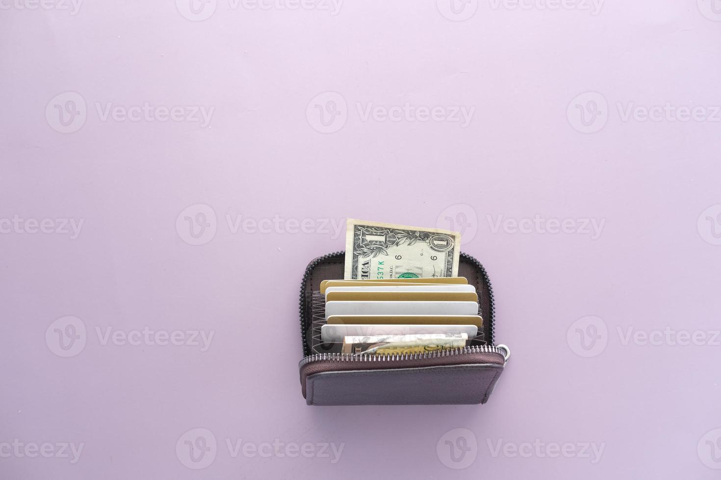 bank cards and cash in a wallet on color background photo