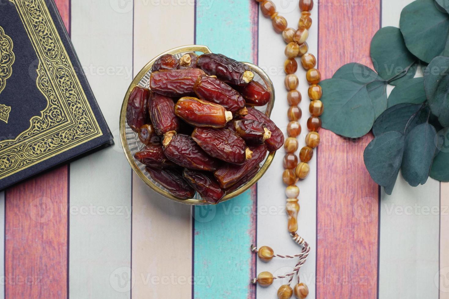 Holy book Quran and rosary on table, close up. photo