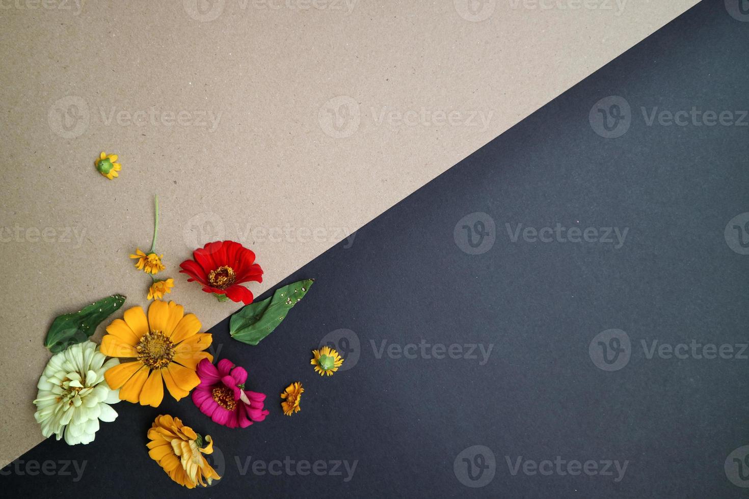 Beautiful flower flat lay arrangement on black and brown background. Flat lay bouquet, top view, overhead, empty space for copied text. photo