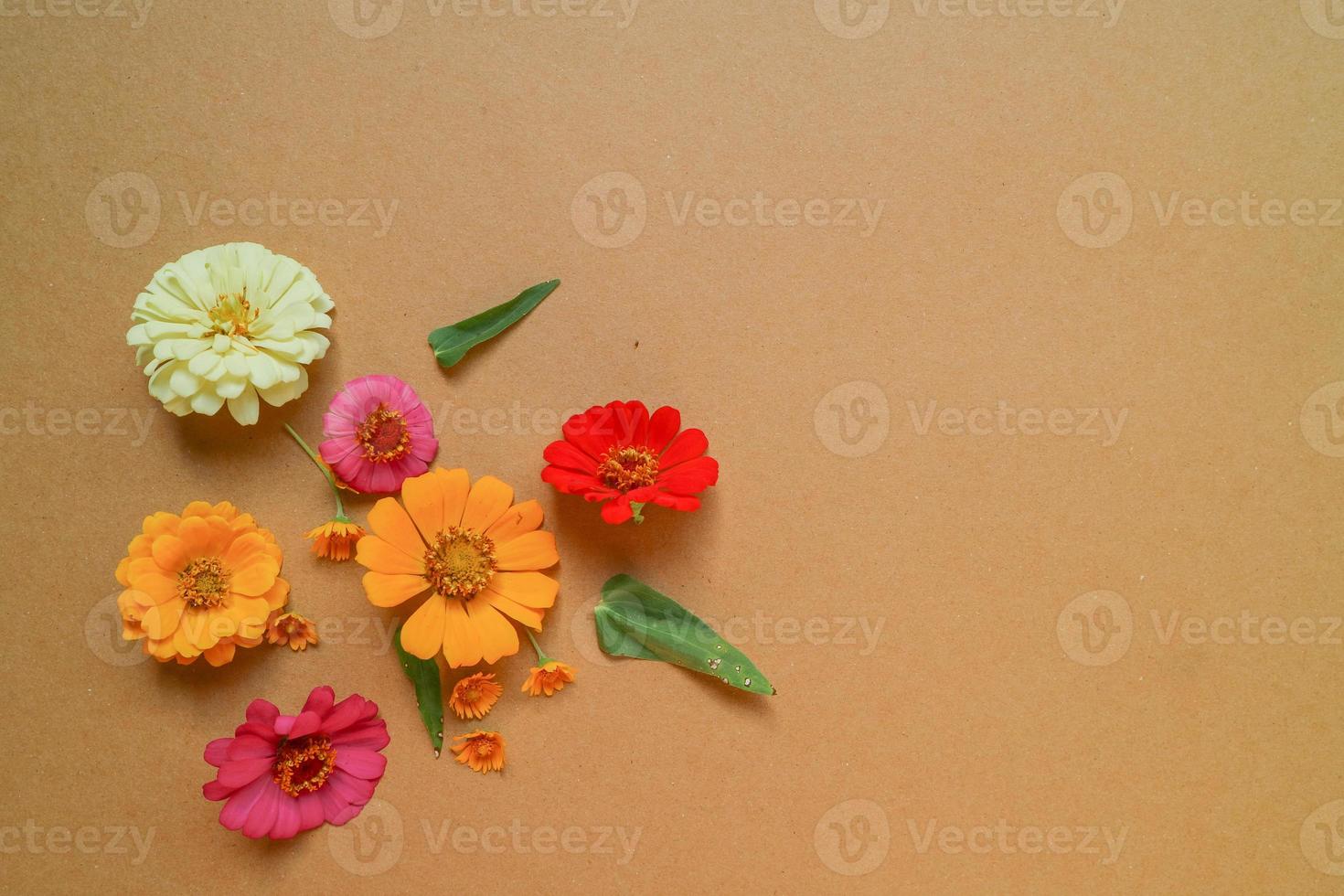 Beautiful flower flat lay arrangement on brown background. Flat lay bouquet, top view, overhead, empty space for copied text. photo