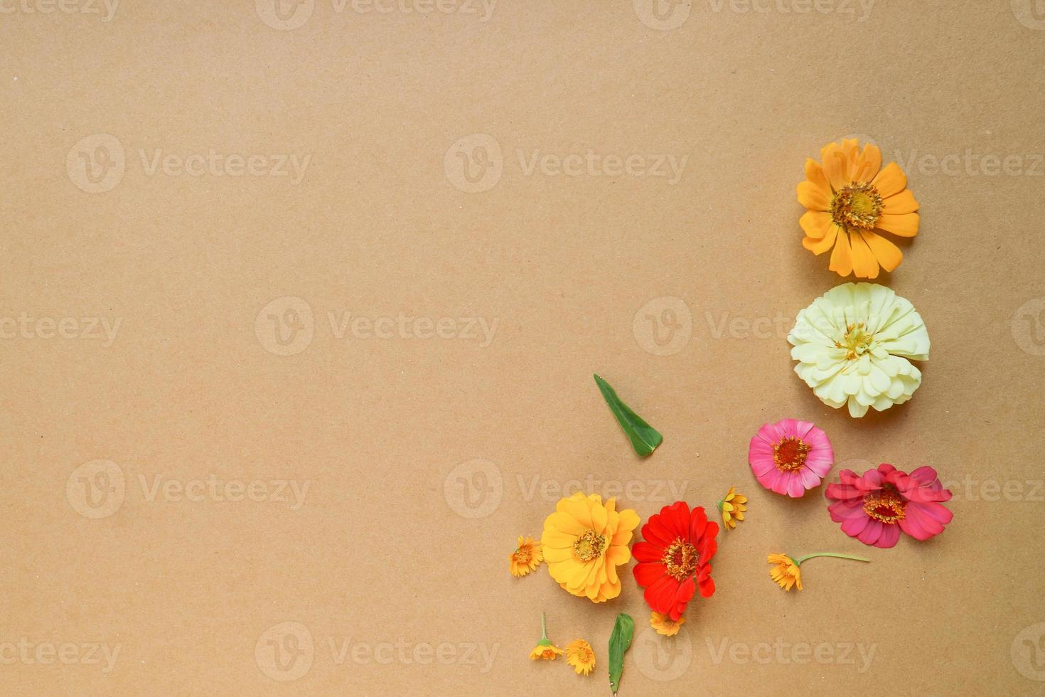 Beautiful flower flat lay arrangement on brown background. Flat lay bouquet, top view, overhead, empty space for copied text. photo