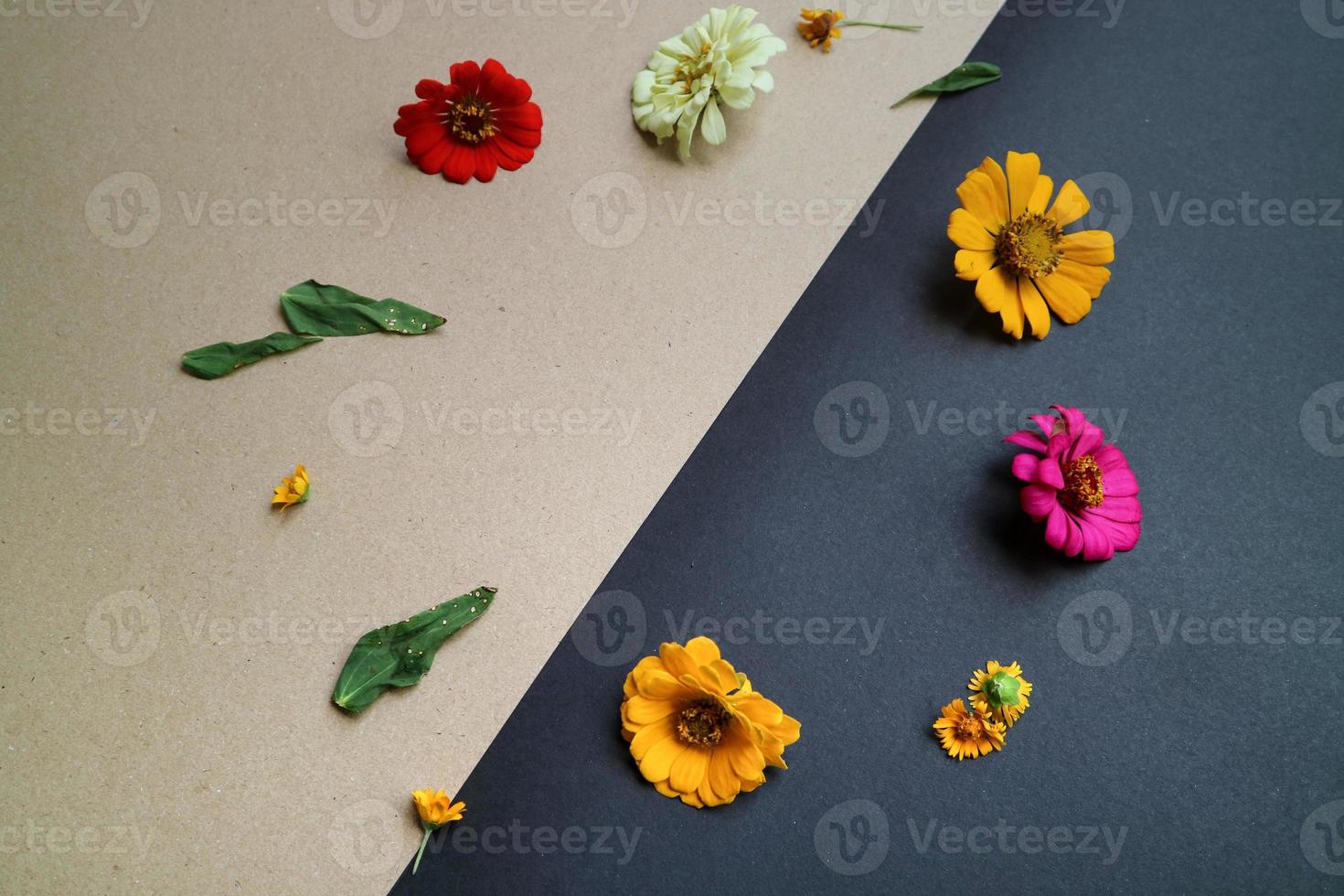 Beautiful flower flat lay arrangement on black and brown background. Flat lay bouquet, top view, overhead, empty space for copied text. photo