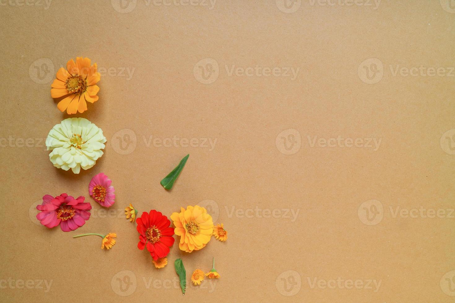 Beautiful flower flat lay arrangement on brown background. Flat lay bouquet, top view, overhead, empty space for copied text. photo
