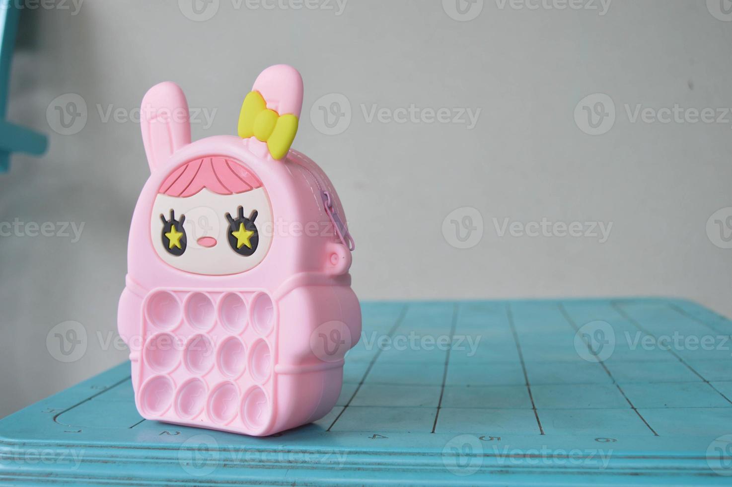 pop it childrens toys combined into a small bag. cute pink object. photo