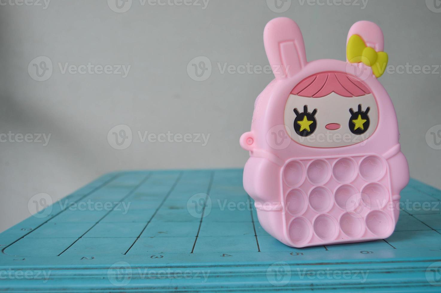 pop it childrens toys combined into a small bag. cute pink object. photo