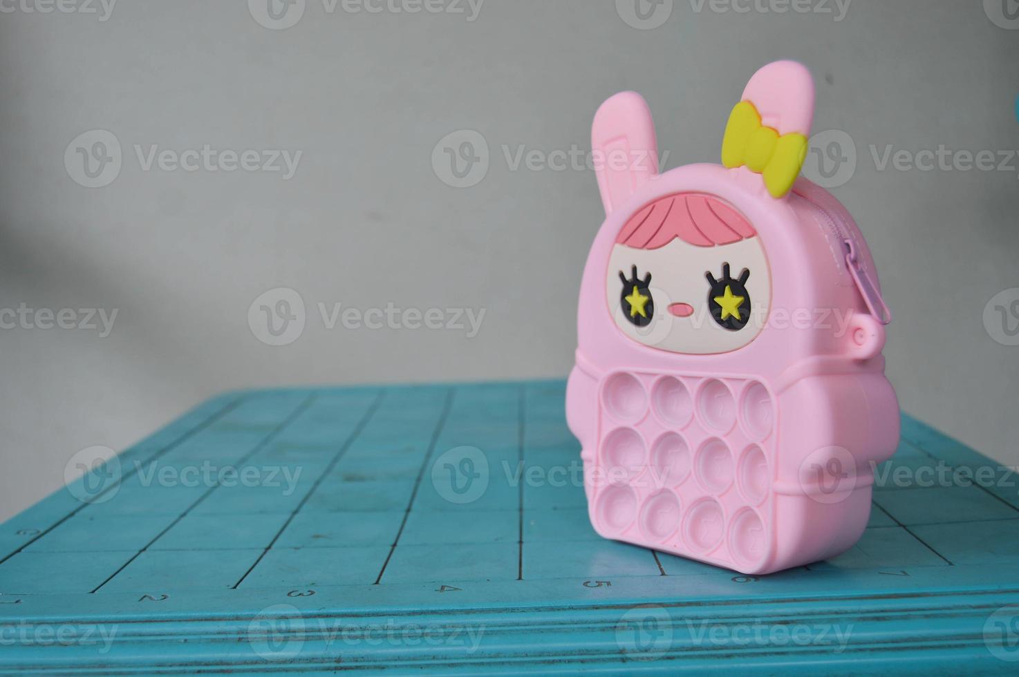 pop it childrens toys combined into a small bag. cute pink object. photo