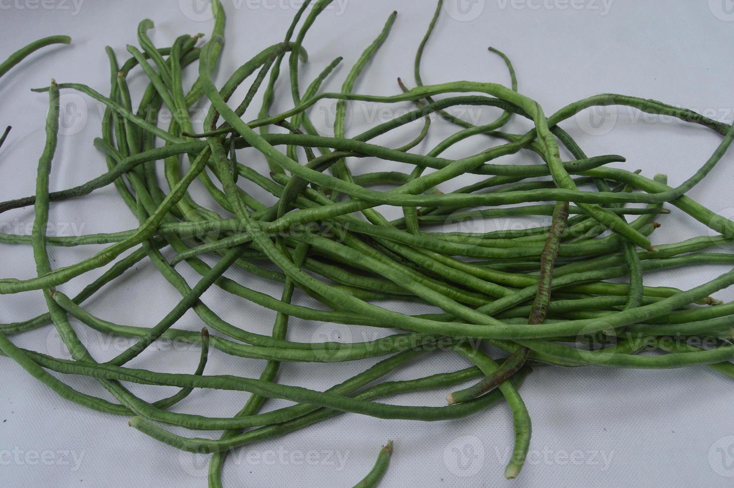 string beans on a white background. food material. source of vitamins. food menu for iftar. photo