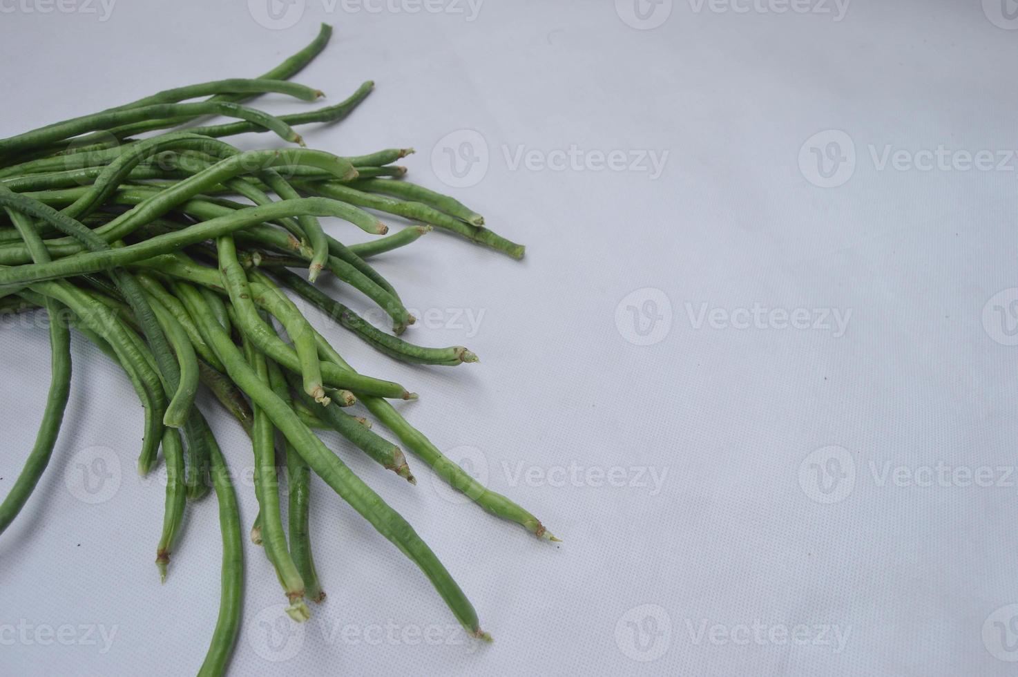 string beans on a white background. food material. source of vitamins. food menu for iftar. photo