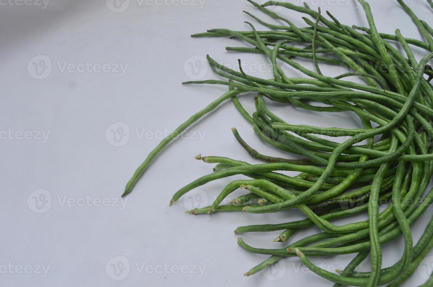 string beans on a white background. food material. source of vitamins. food menu for iftar. photo