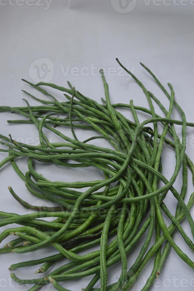 string beans on a white background. food material. source of vitamins. food menu for iftar. photo