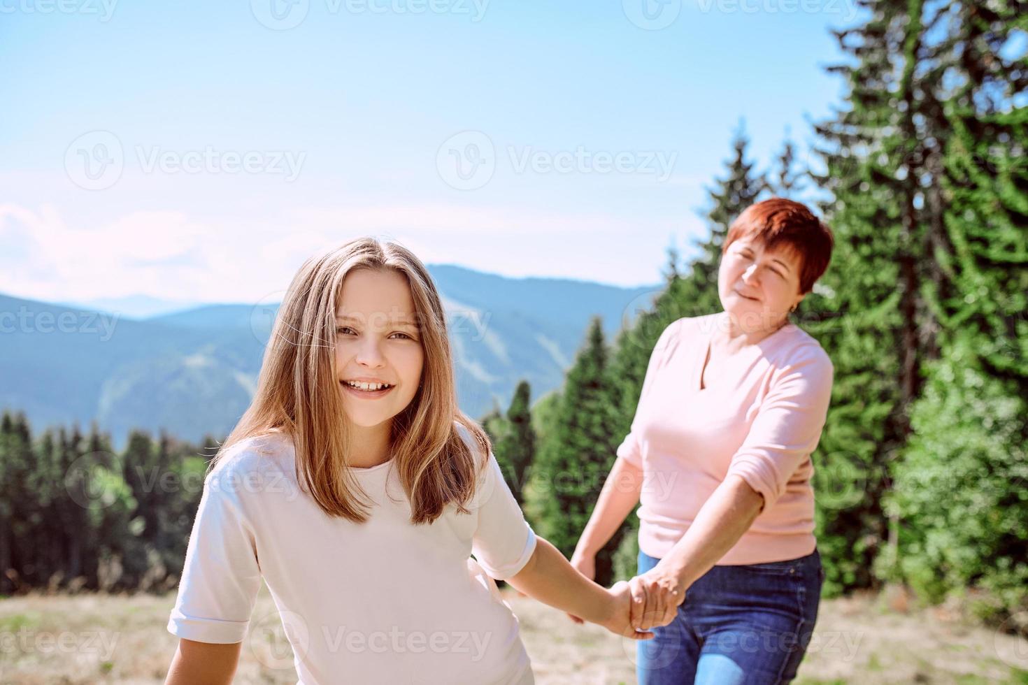 family grandmother and mother in mountains happy to travel. Leisure family time, summer concept photo